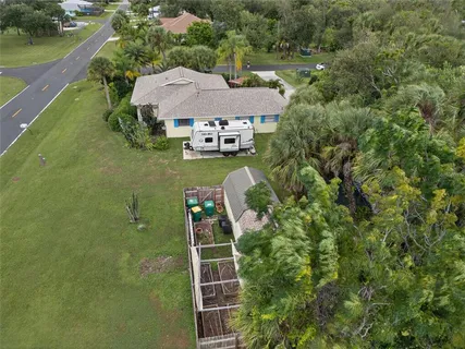 an aerial view of a house with a yard