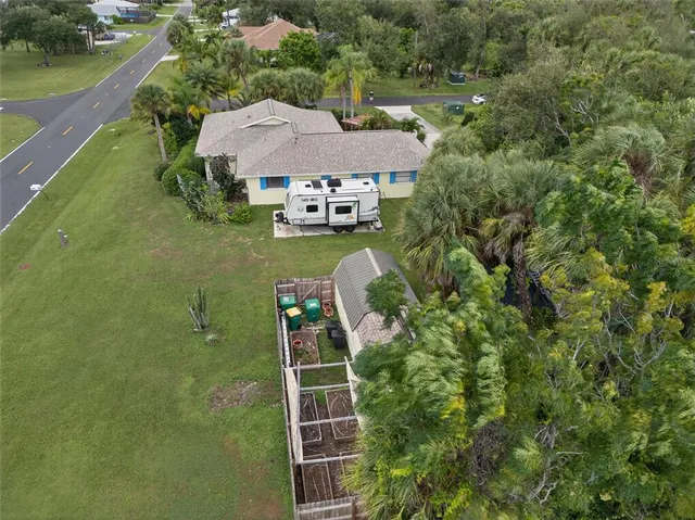 an aerial view of a house with a yard