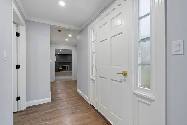 a view of a hallway with wooden floor and closet