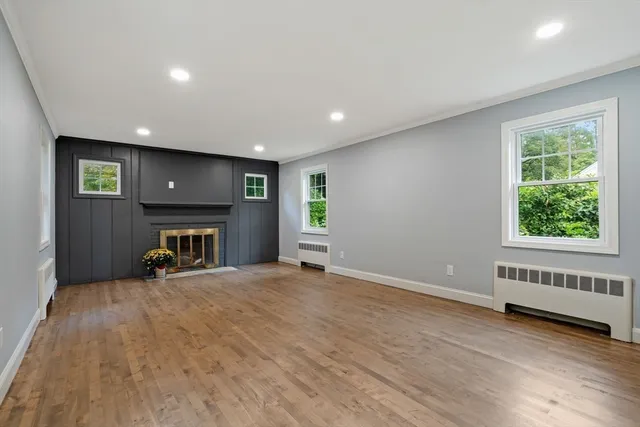 an empty room with furniture and a window
