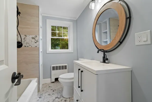 a bathroom with a sink a toilet and a mirror
