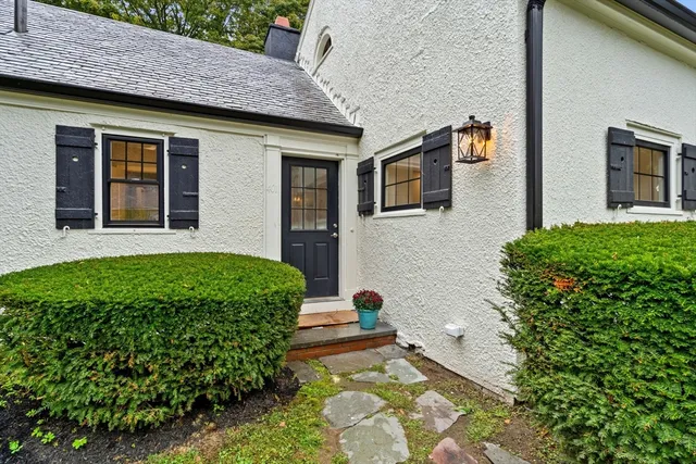 a front view of a house with garden