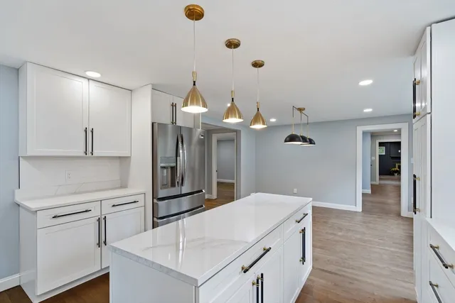a kitchen with cabinets and wooden floor