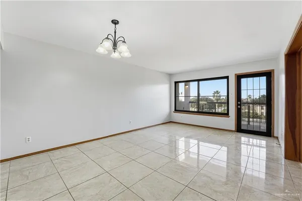 a view of a kitchen with wooden cabinet and a refrigerator