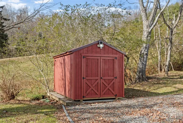 a front view of a house with a yard covered with snow