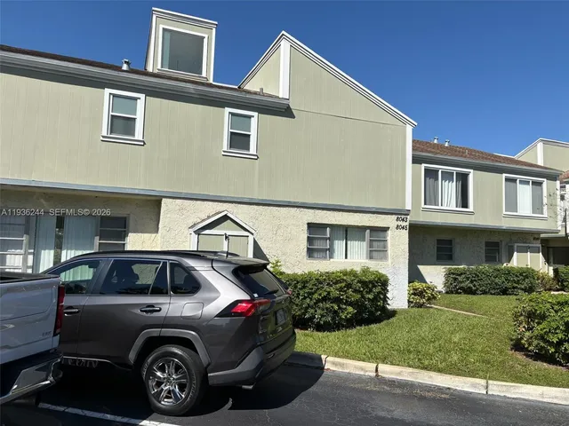 a view of a car parked in front of a house