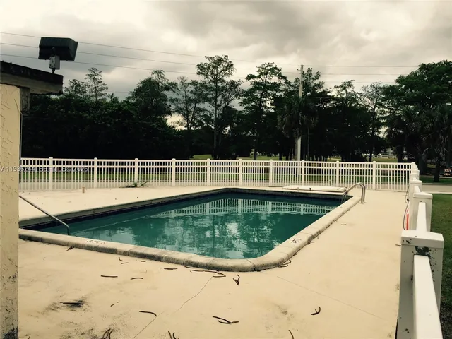 a view of a swimming pool with a yard