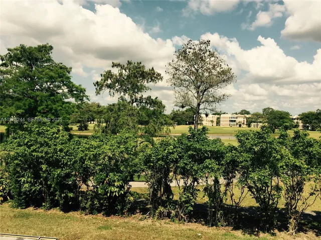 a view of a swimming pool with a yard