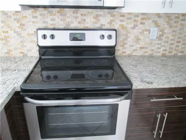 a stove top oven sitting inside of a kitchen
