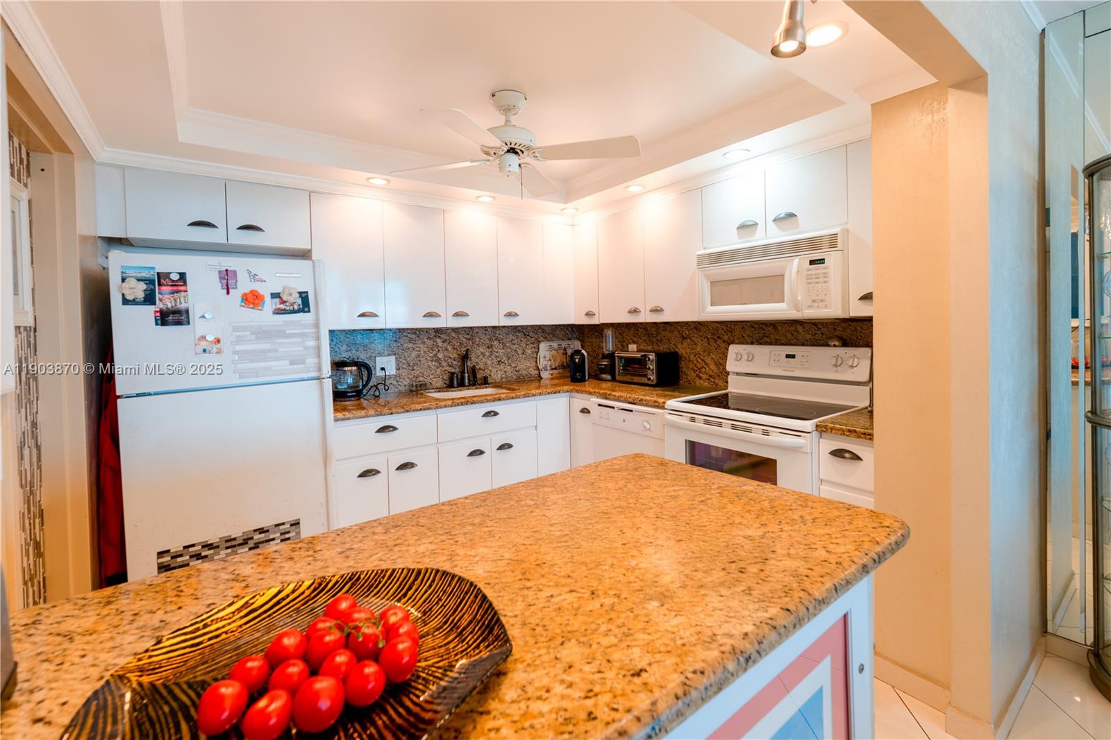 2101 South Ocean Drive, Unit 2002 Hollywood, FL 33019 - Photo 12 of 23 a kitchen with granite countertop a refrigerator and a stove top oven