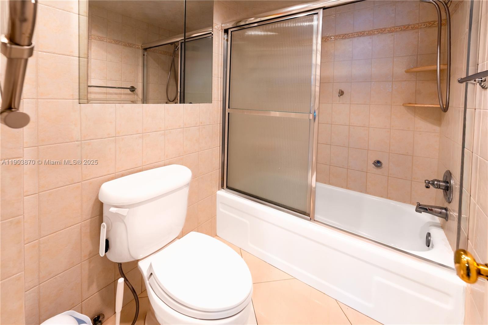 2101 South Ocean Drive, Unit 2002 Hollywood, FL 33019 - Photo 18 of 23 a white toilet sitting next to a bath tub and a shower