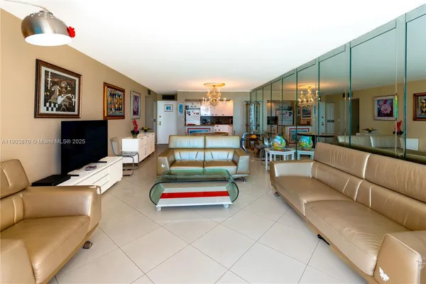 a living room with furniture and kitchen view