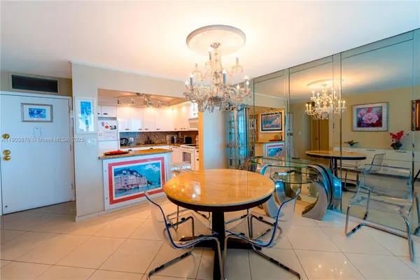 a view of a dining room with furniture and chandelier