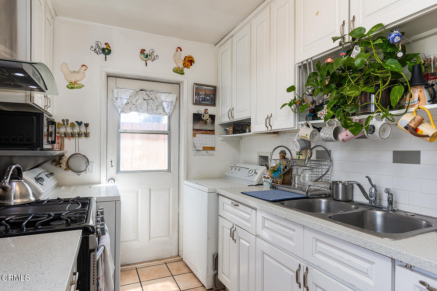 504 North Catalina Avenue Pasadena, CA 91106 - Photo 25 of 42 a kitchen with sink a potted plant and cabinets