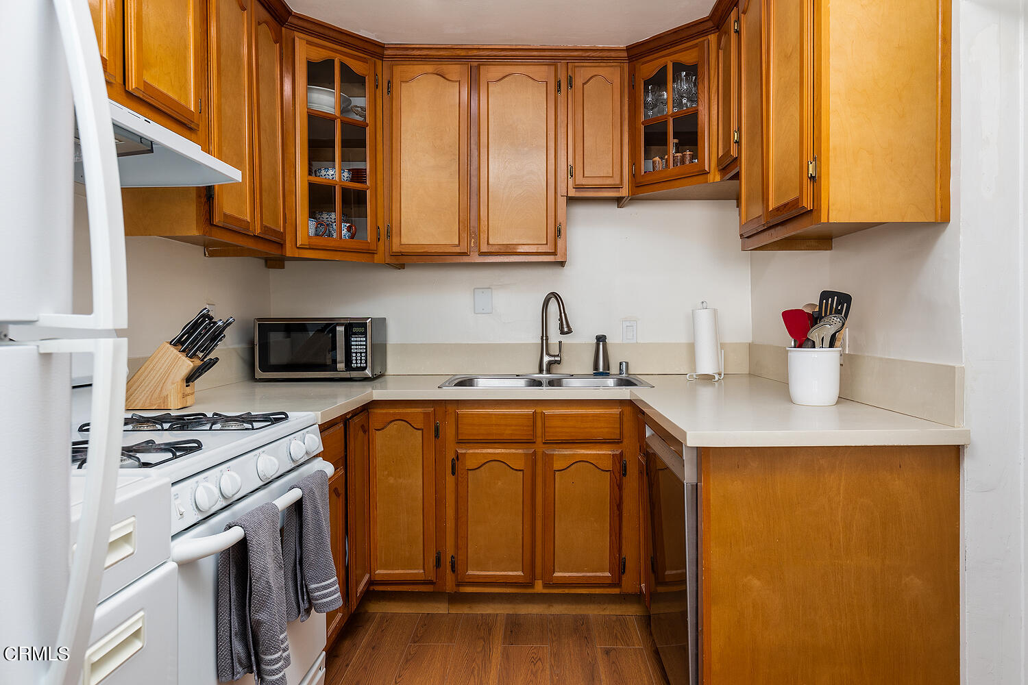 504 North Catalina Avenue Pasadena, CA 91106 - Photo 10 of 42 a kitchen with stainless steel appliances granite countertop a sink a stove and cabinets