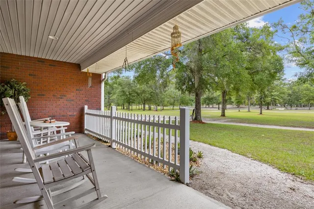 a living room with furniture a fireplace and a ceiling fan