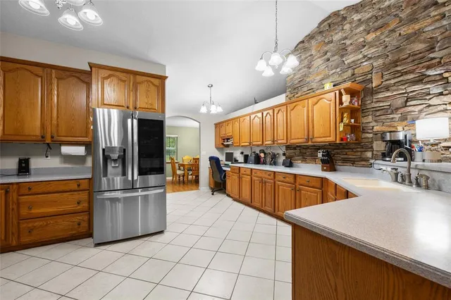 a kitchen with stainless steel appliances granite countertop a sink counter space cabinets and a stove