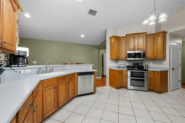 a view of a dining room with furniture wooden floor and chandelier