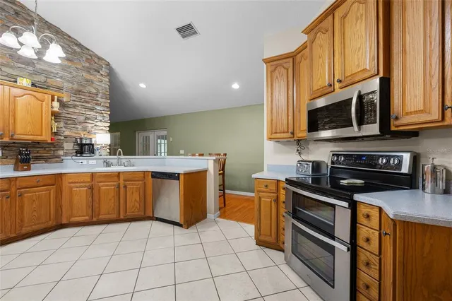 a dining room with furniture and chandelier