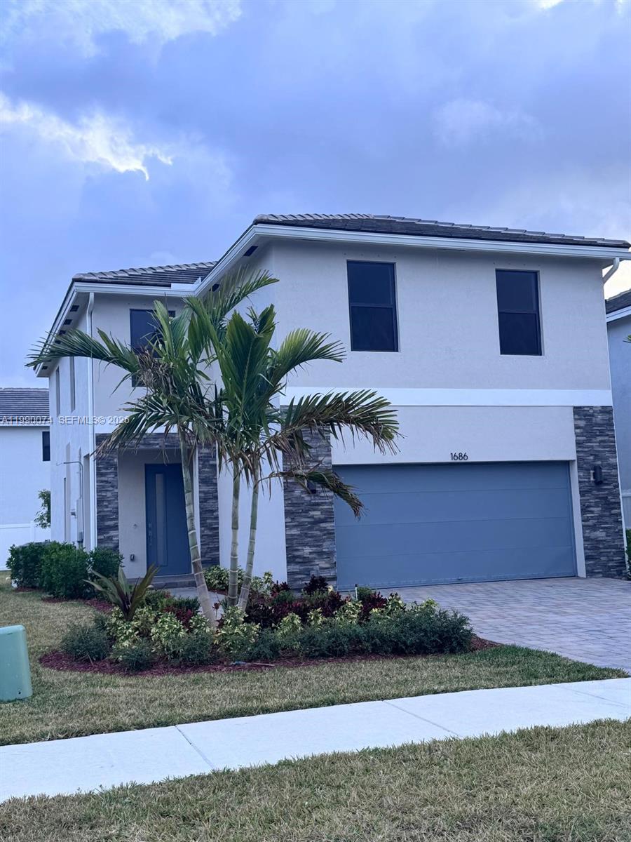 1686 Southeast 6th Street Homestead, FL 33033 - Photo 1 of 3 a front view of a house with a yard