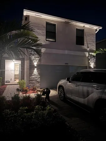 a front view of a house with parking space