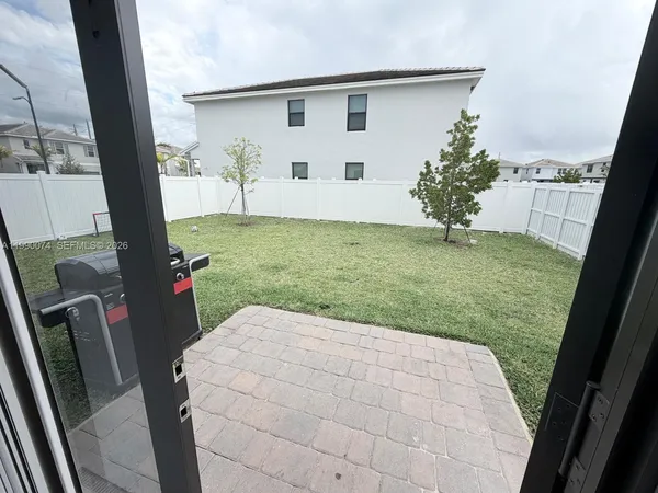 a view of backyard with patio