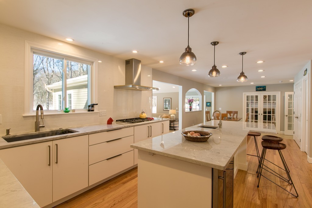 205 Hunters Ridge Road Concord, MA 01742 - Photo 8 of 28 a kitchen with stainless steel appliances granite countertop a sink stove and refrigerator