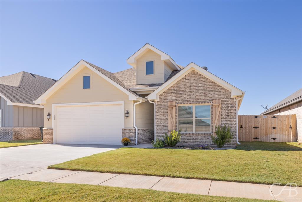 6566 Stadium Drive Abilene, TX 79606 - Photo 1 of 1 a front view of a house with a yard and garage