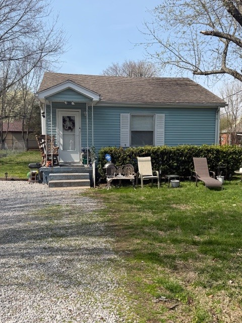 a front view of a house with a garden and porch