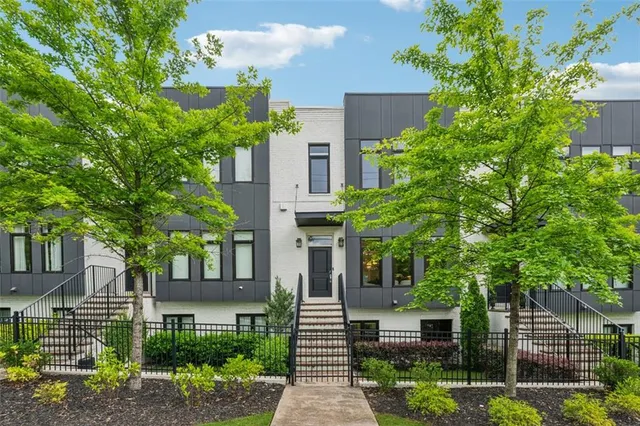 a front view of a house with a tree