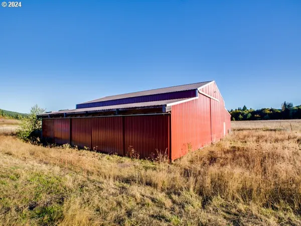 a view of a garage with a car and a roof