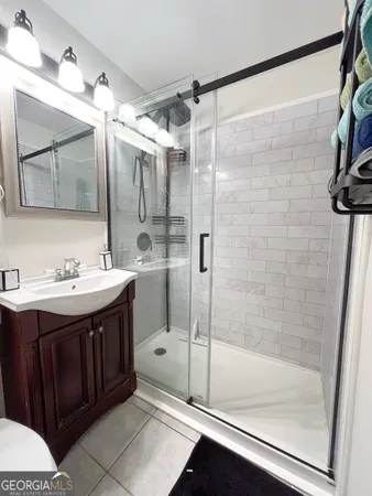 a bathroom with a shower sink and mirror