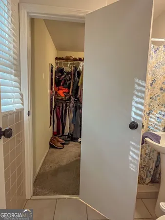 a view of walk in closet with clothes
