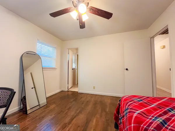 a bedroom with a bed and a mirror