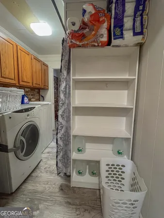 a view of storage and utility room with washer and dryer