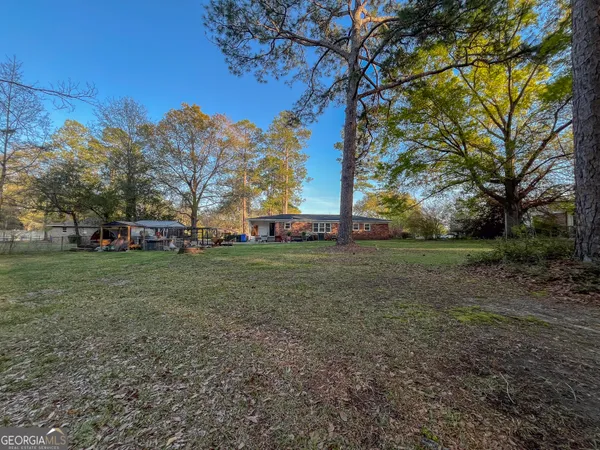 a view of a yard with a tree