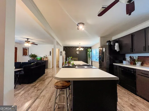 a kitchen with a table chairs refrigerator and microwave