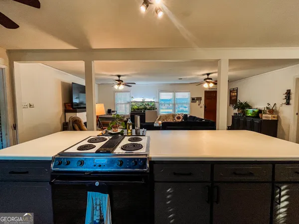a room with pool table and chairs