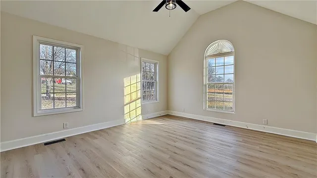 an empty room with windows and closet