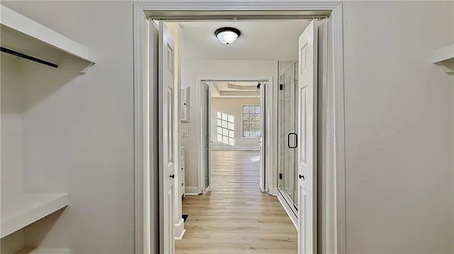 a view of a hallway with wooden floor