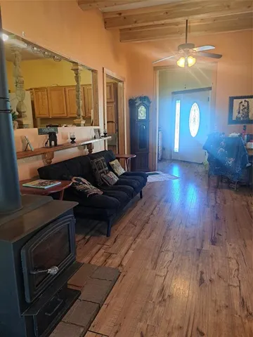 a view of a living room and kitchen with wooden floor