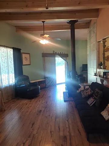 a living room with furniture and a hard wood floor
