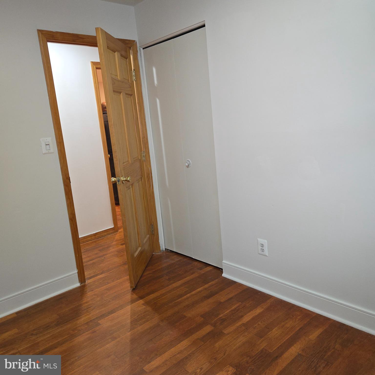 3505 Templar Road Randallstown, MD 21133 - Photo 15 of 40 an empty room with wooden floor and a hallway