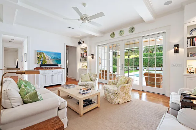 a living room with furniture and large windows