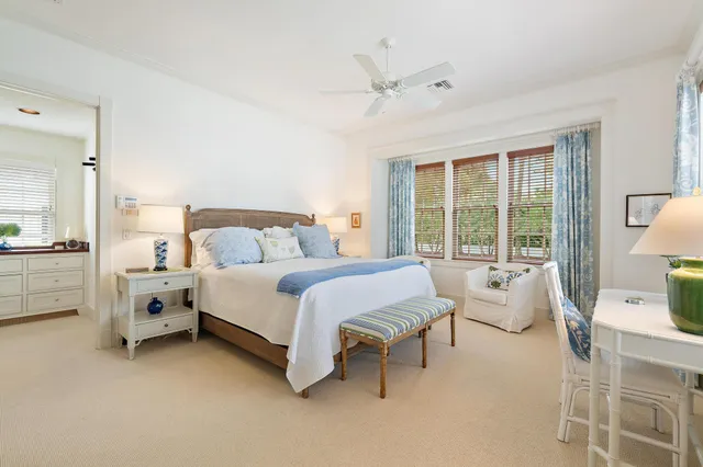 a spacious bedroom with a bed and a large window