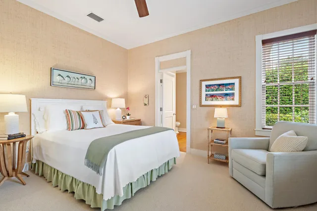 a bedroom with a bed couch and a window