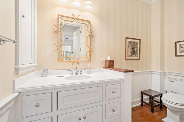 a en suite bathroom with a granite countertop sink and a mirror