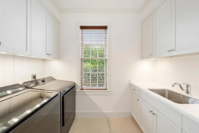 a kitchen with a sink cabinets and window