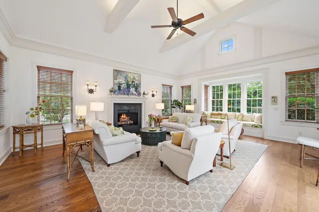 a living room with furniture a large window and a fireplace