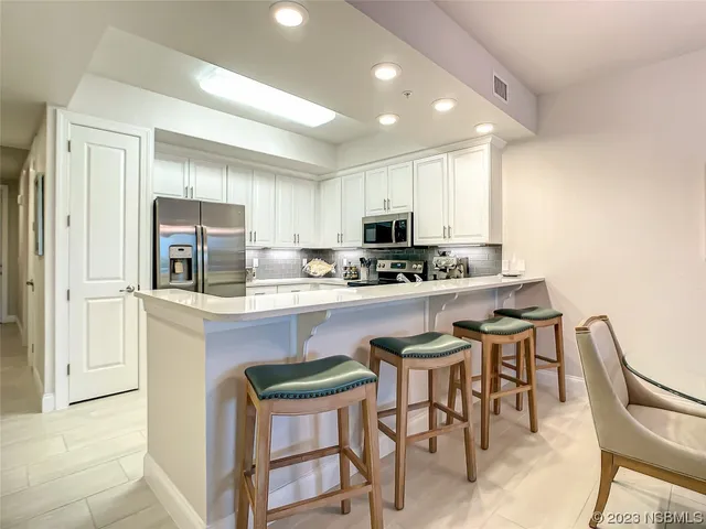 a dining room with furniture a chandelier and window